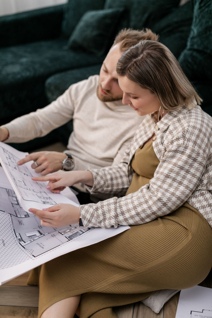 Couple reviewing a floor plan together while planning their home renovation