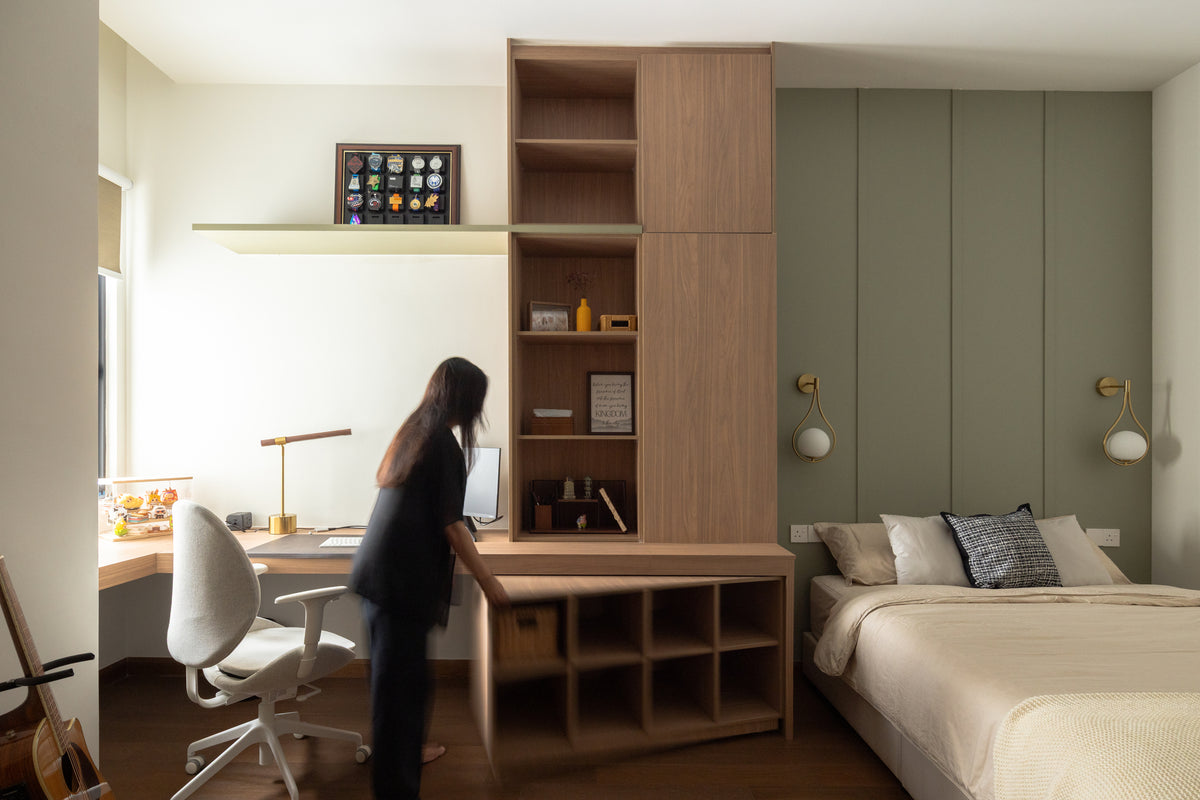 Cheras bedroom with fitted oak study desk, shelving and a sage panelled headboard wall