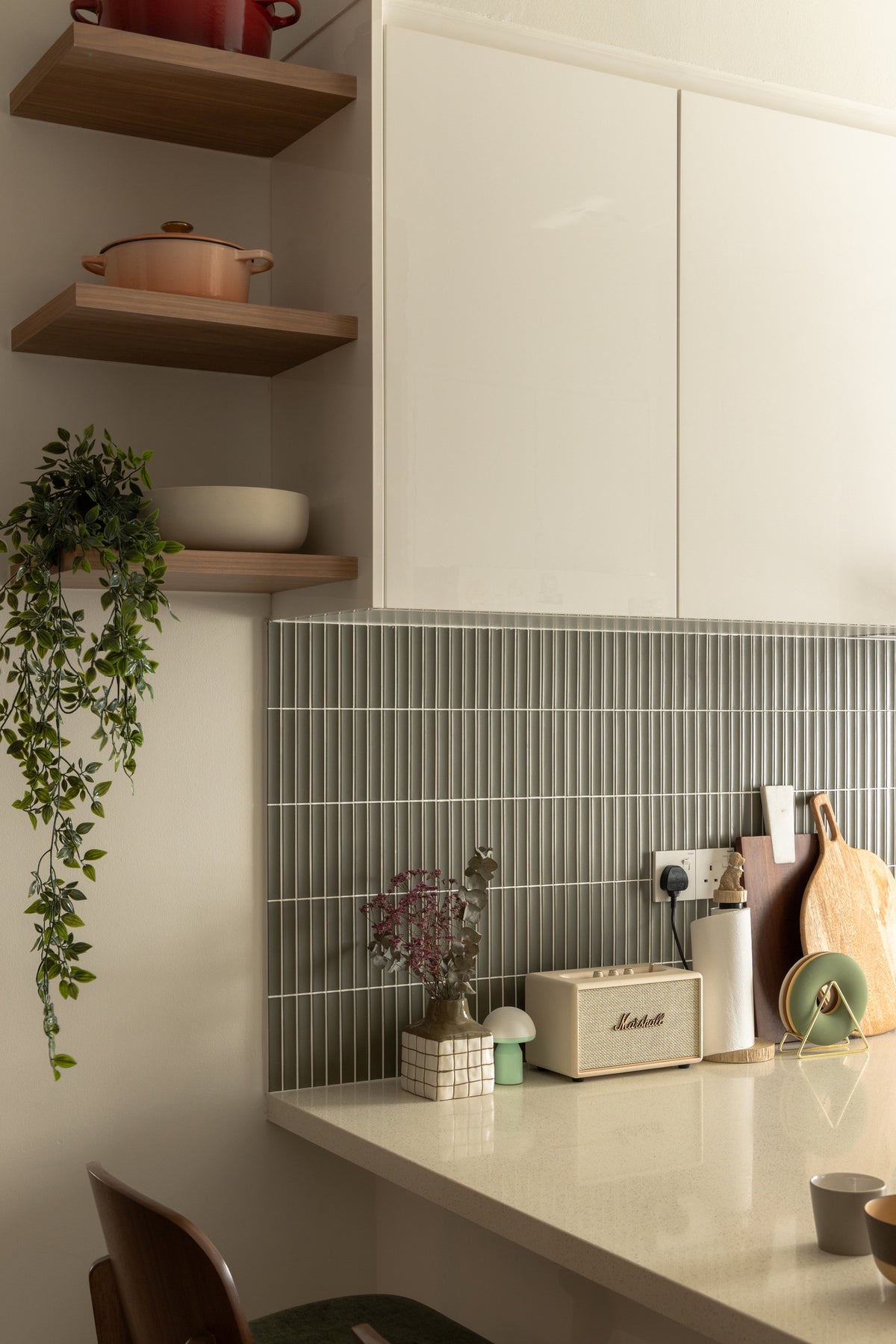 A kitchen corner with sage stick tiles, timber open shelves and a quartz counter, in a home Sundays in Bed designed at Bangsar Hill Park, Bangsar