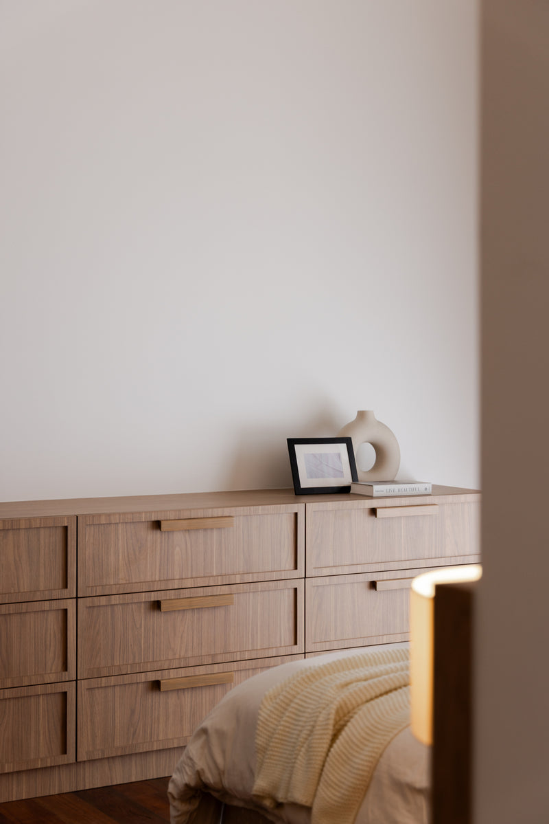 Bedroom with a built-in upholstered headboard and light oak wardrobes, in a home Sundays in Bed designed at Setia Sky Seputeh, Seputeh