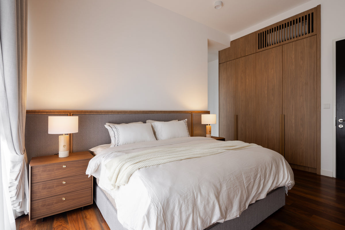A bedroom with walnut wardrobes to the ceiling and a padded headboard, in a home Sundays in Bed designed at Setia Sky Seputeh, Seputeh